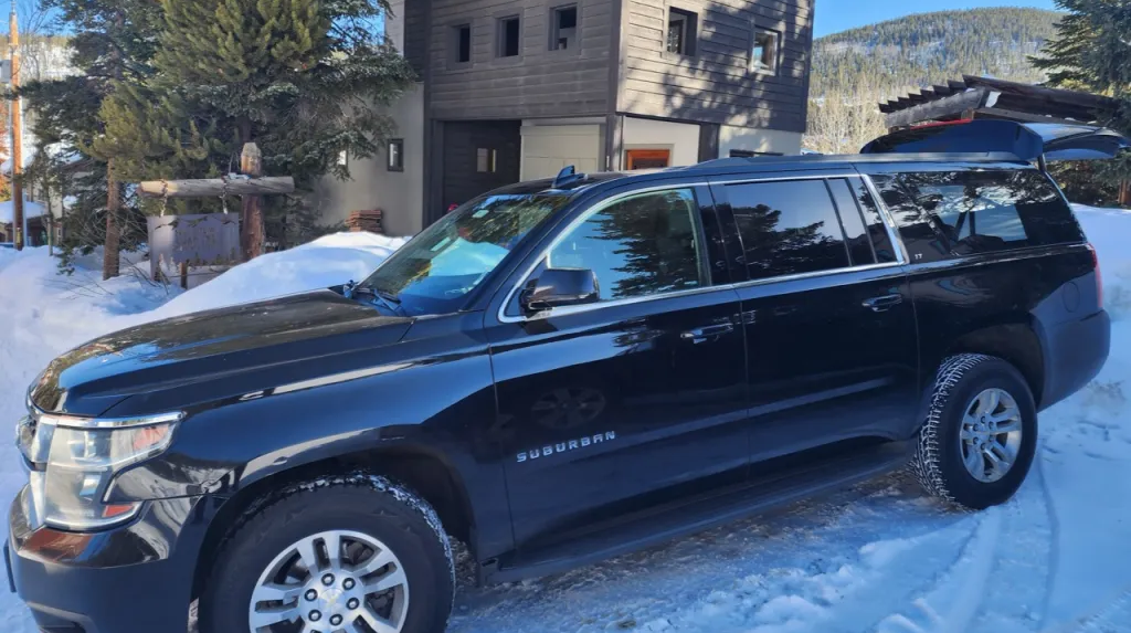 Luxury black car transporting passengers from Denver to Winter Park