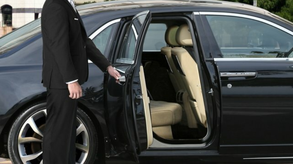 Chauffeur driving corporate executives in a luxury black car in Denver